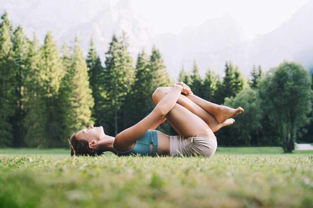 Yoga on nature. Young woman is practicing yoga in mountains